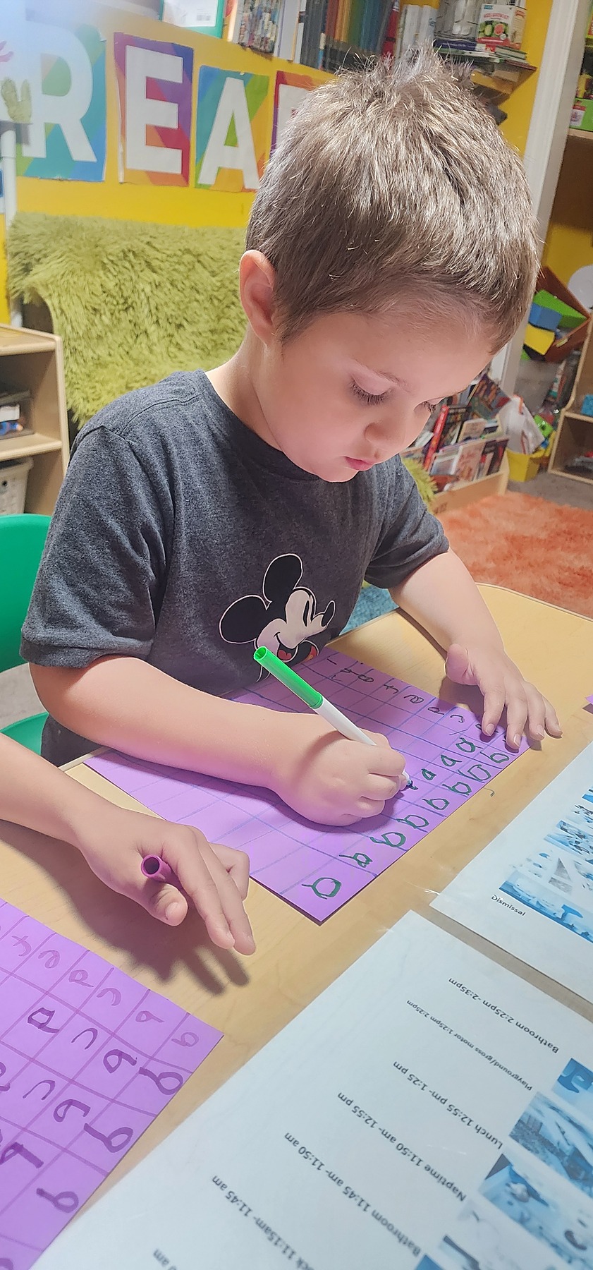 Child practicing handwriting at a table